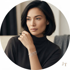 A circular portrait of Jasmine T. wearing a 925 sterling silver Figaro link chain on her wrist against a minimalist backgroun