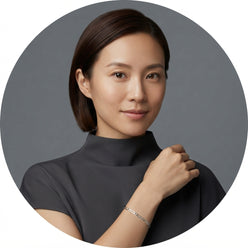 A circular portrait of influencer Sarah Chen wearing a 925 sterling silver Figaro link chain against a slate gray background.